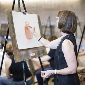Woman drawing at an easel