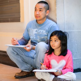 child with parent drawing in gallery